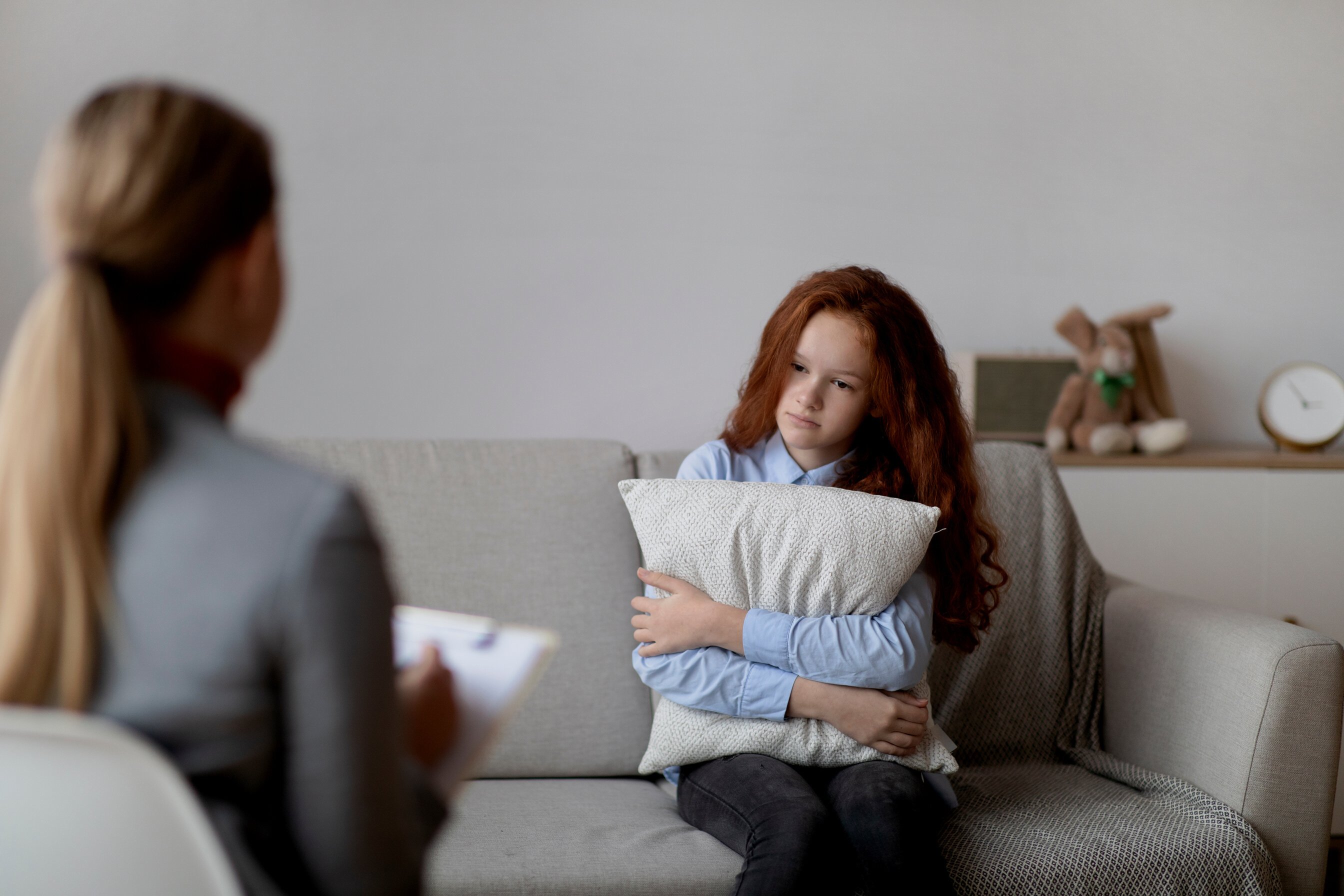 Child Psychologist. Sad teen girl having consultation